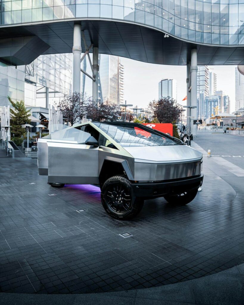 tesla cybertruck with purple underlights parked under a bridge in downtown Las Vegas