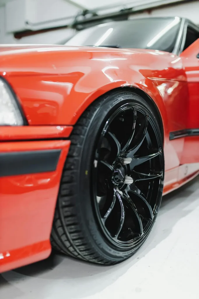 close up of a red sports car that has just undergone professional paint correction